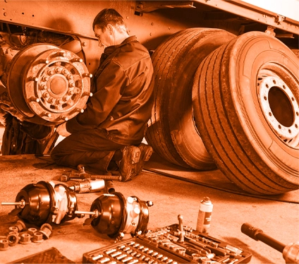 Mechanic working on a large vehicle